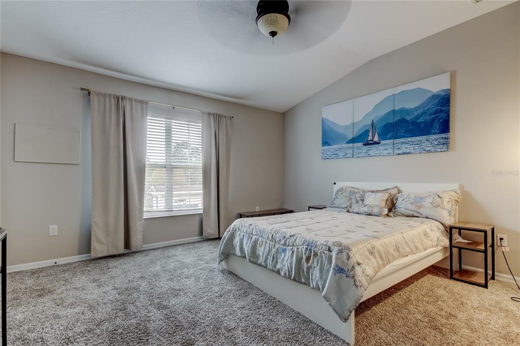 1138 Hillhurst Drive Wesley Chapel, FL 33543 - Photo 24 of 65 a bedroom with a bed and a window