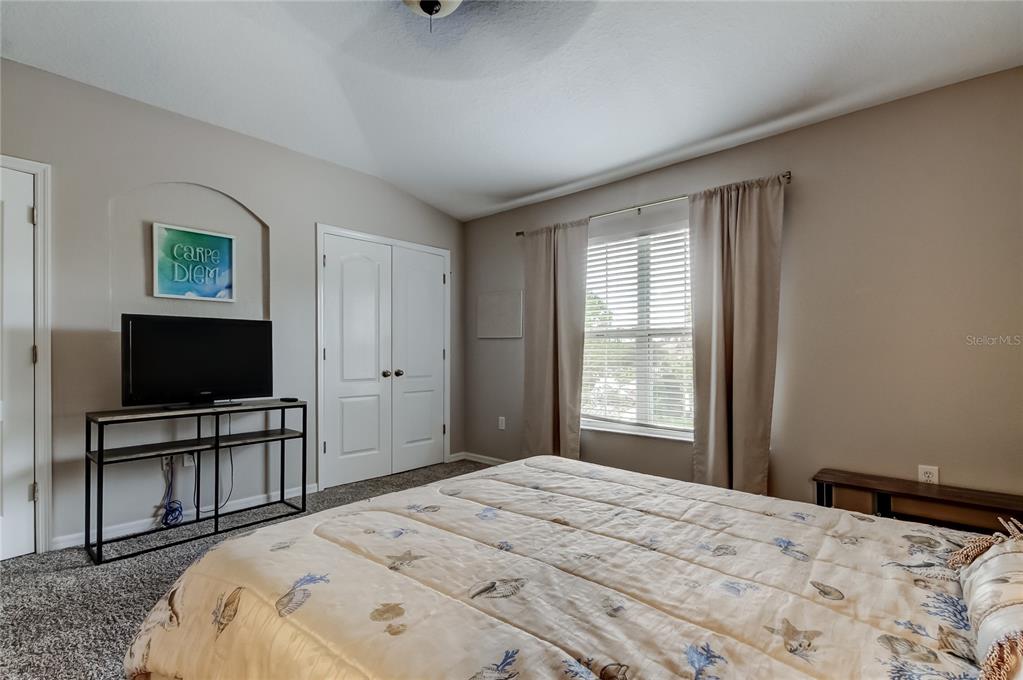 1138 Hillhurst Drive Wesley Chapel, FL 33543 - Photo 25 of 65 a bedroom with a bed and a flat screen tv
