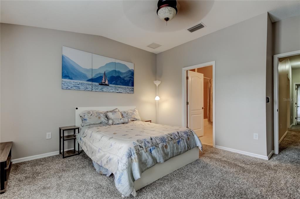 1138 Hillhurst Drive Wesley Chapel, FL 33543 - Photo 26 of 65 a bedroom with a bed and wall painting