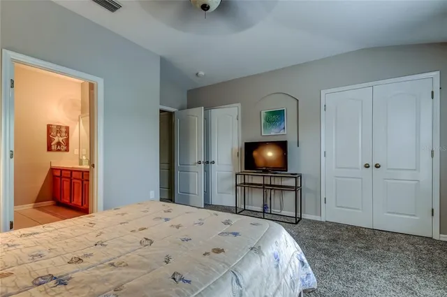 a bedroom with a bed and a chair