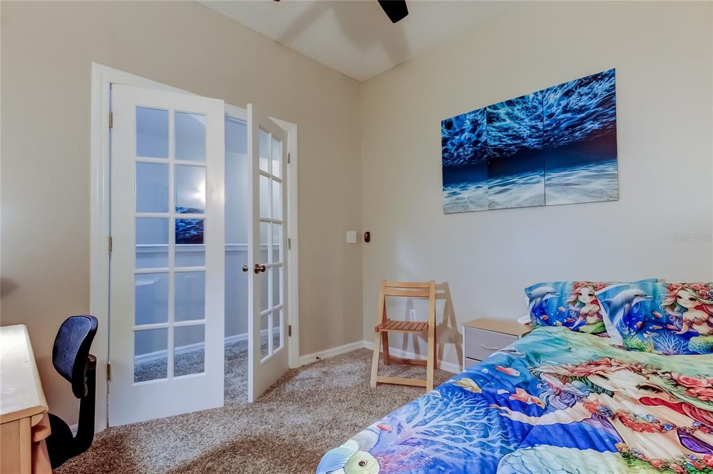 1138 Hillhurst Drive Wesley Chapel, FL 33543 - Photo 32 of 65 a bedroom with a bed and a chair