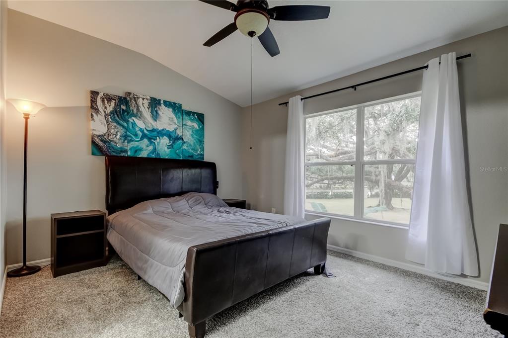 1138 Hillhurst Drive Wesley Chapel, FL 33543 - Photo 33 of 65 a bed sitting in a bedroom next to a window