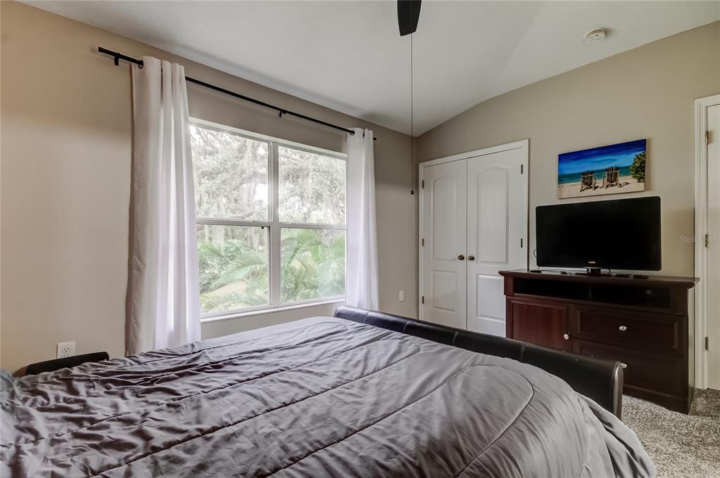 1138 Hillhurst Drive Wesley Chapel, FL 33543 - Photo 34 of 65 a bedroom with a bed and a flat screen tv