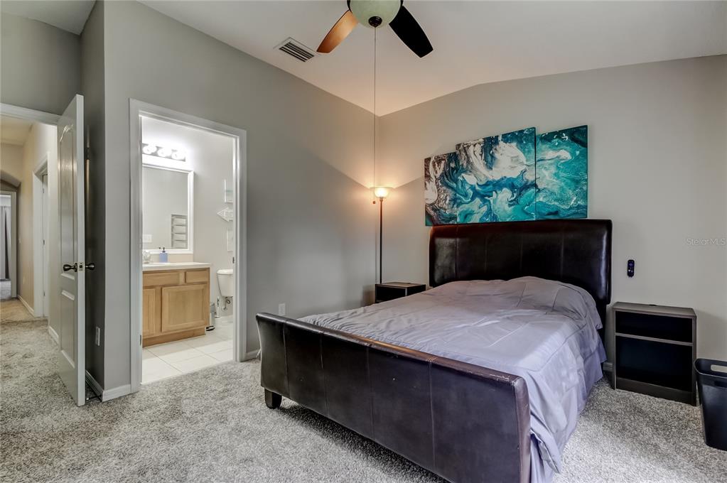 1138 Hillhurst Drive Wesley Chapel, FL 33543 - Photo 35 of 65 a bedroom with a bed and a dresser