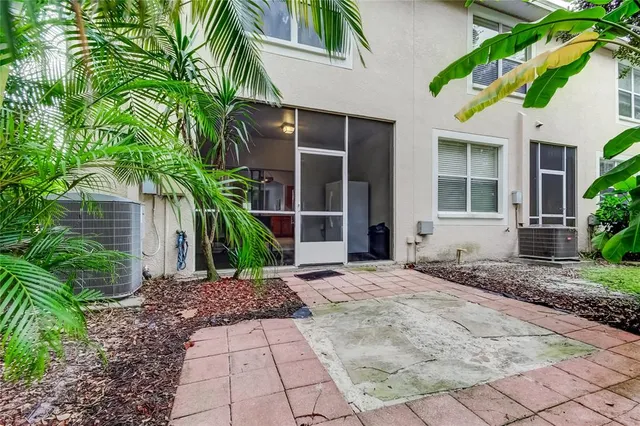 a view of a house with backyard and sitting area