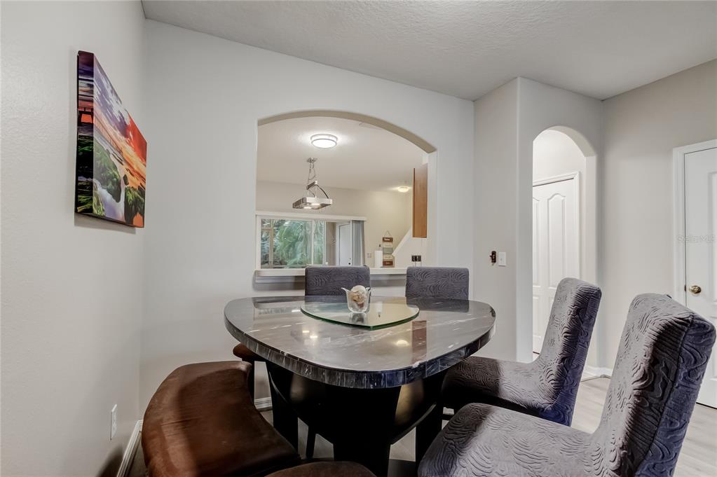 1138 Hillhurst Drive Wesley Chapel, FL 33543 - Photo 47 of 65 a view of a dining room with furniture and wooden floor