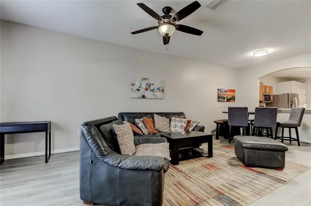 a living room with furniture and a wooden floor