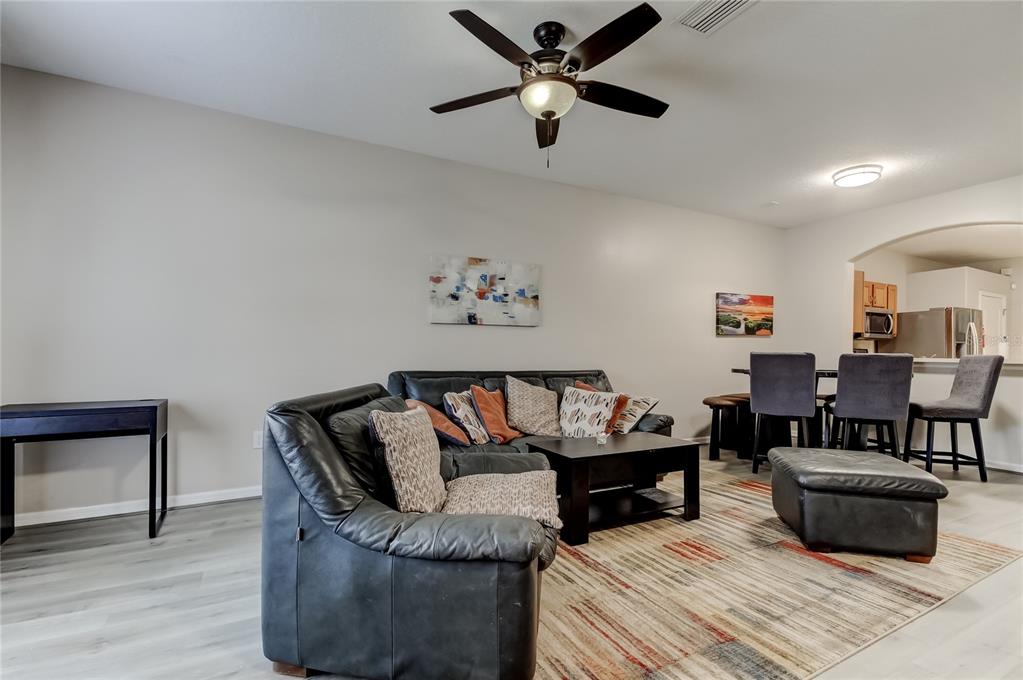 1138 Hillhurst Drive Wesley Chapel, FL 33543 - Photo 6 of 65 a living room with furniture and a wooden floor