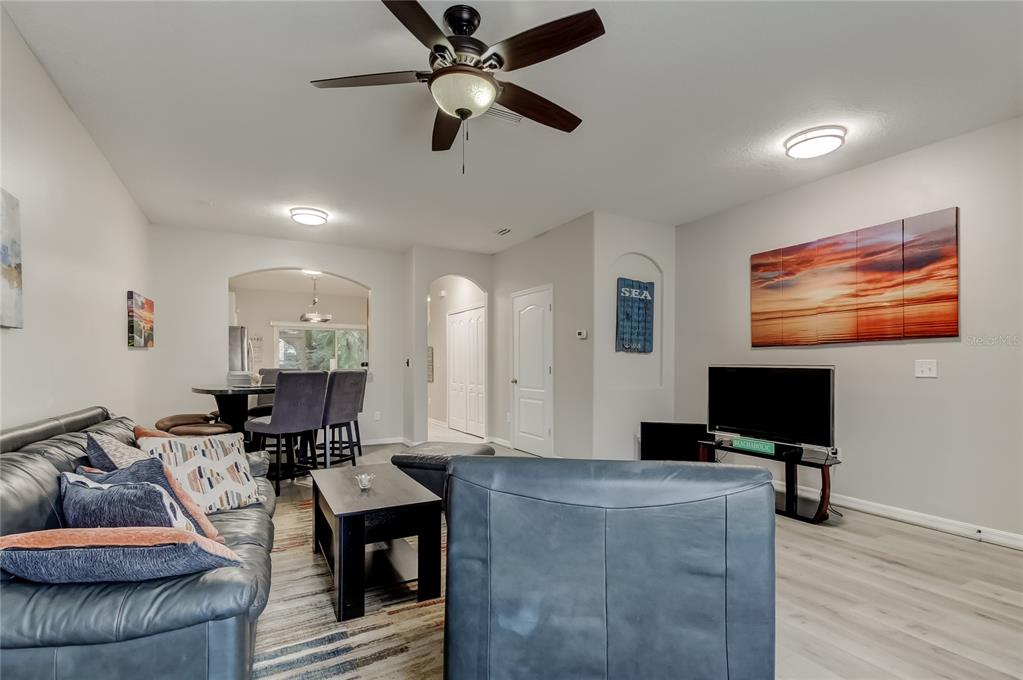 1138 Hillhurst Drive Wesley Chapel, FL 33543 - Photo 7 of 65 a living room with furniture and a flat screen tv