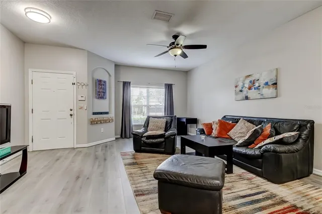 a living room with furniture and wooden floor