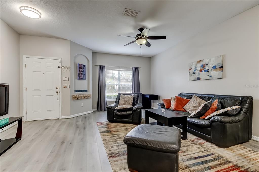 1138 Hillhurst Drive Wesley Chapel, FL 33543 - Photo 8 of 65 a living room with furniture and a wooden floor