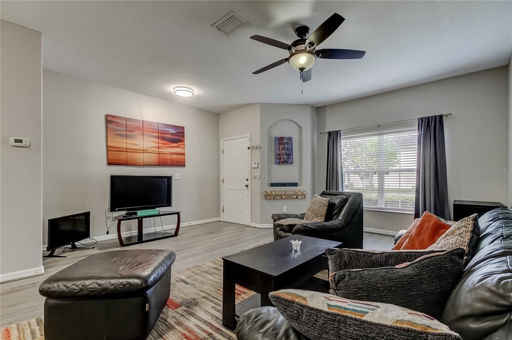1138 Hillhurst Drive Wesley Chapel, FL 33543 - Photo 9 of 65 a living room with furniture and a flat screen tv