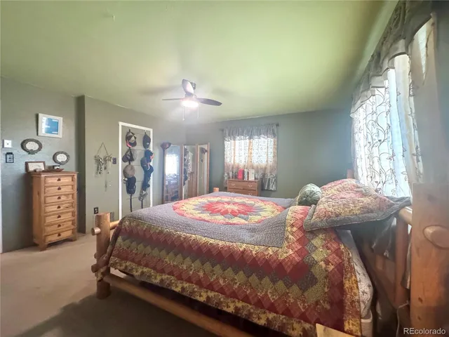 a bedroom with a bed and a mirror