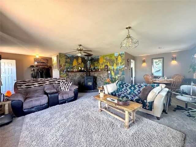 a living room with furniture fireplace and chandelier