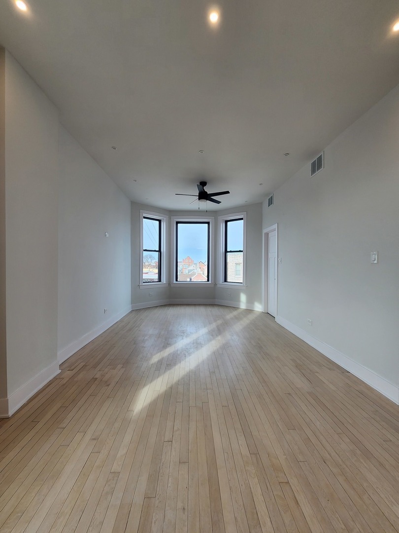 2345 West 23rd Street, Unit 2 Chicago, IL 60608 - Photo 3 of 6 a view of empty room with wooden floor and fan