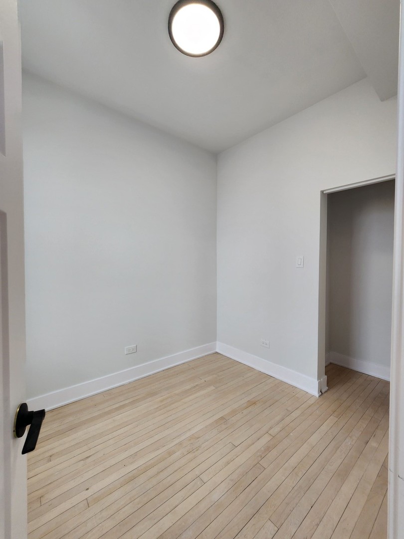 2345 West 23rd Street, Unit 2 Chicago, IL 60608 - Photo 5 of 6 an empty room with wooden floor