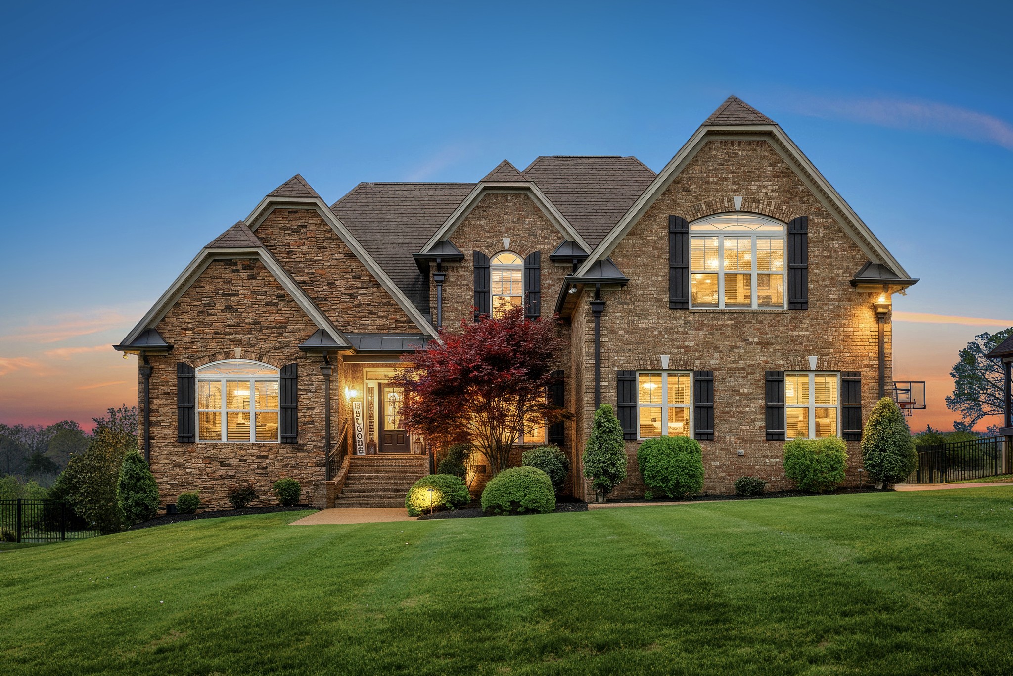 a front view of a house with a garden and plants