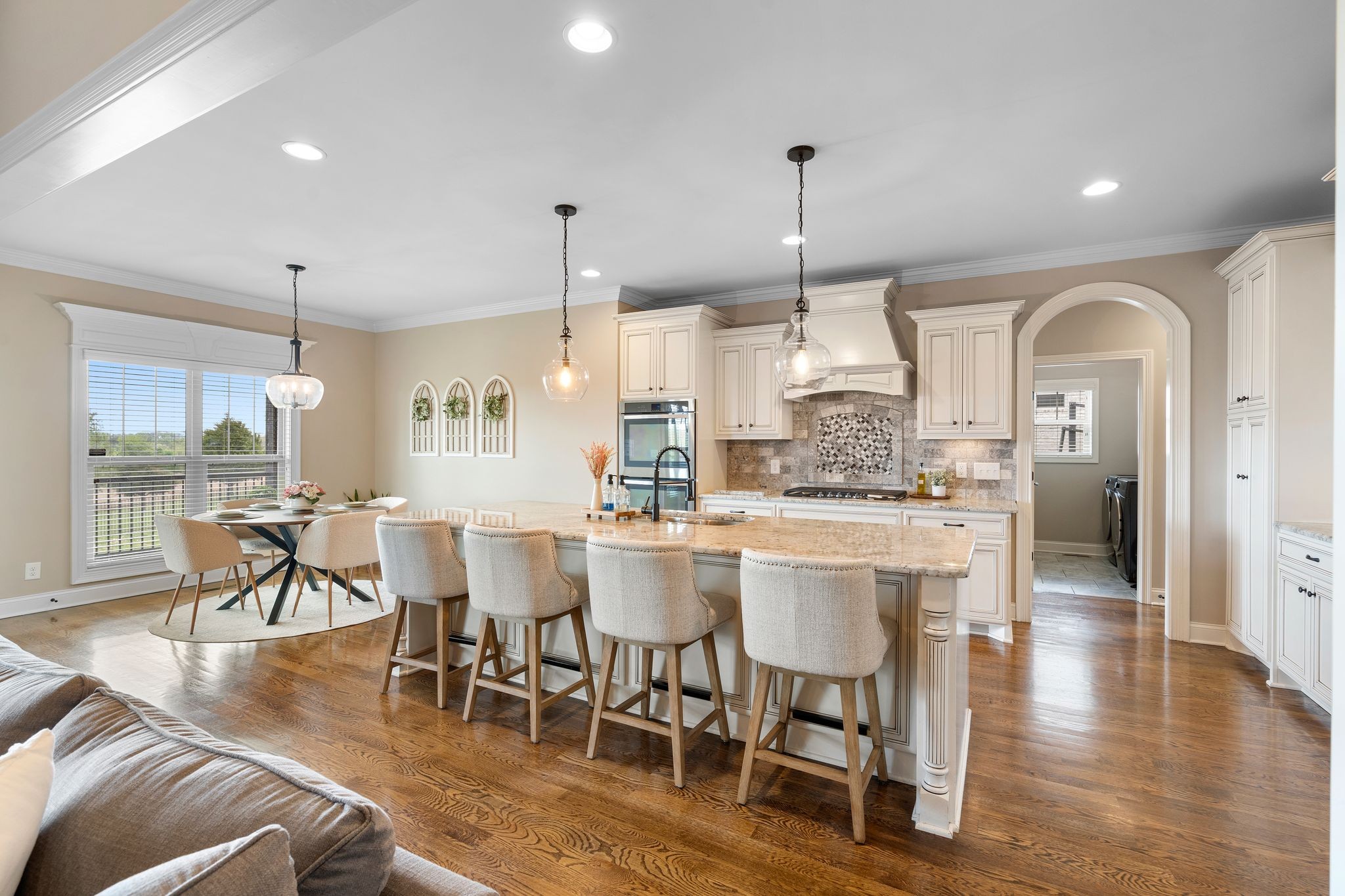 1013 Mires Road Mount Juliet, TN 37122 - Photo 13 of 50 a dining hall with stainless steel appliances granite countertop a stove a sink a refrigerator a dining table and chairs with wooden floor