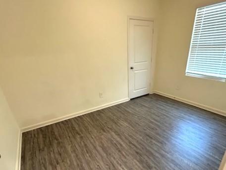 6228 Old Bridge Way Forney, TX 75126 - Photo 3 of 7 an empty room with wooden floor and windows