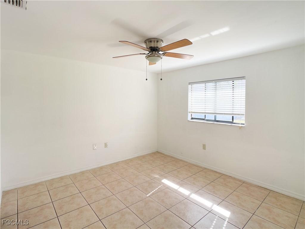 1156 Southwest 47th Terrace Cape Coral, FL 33914 - Photo 4 of 13 an empty room with windows and fan