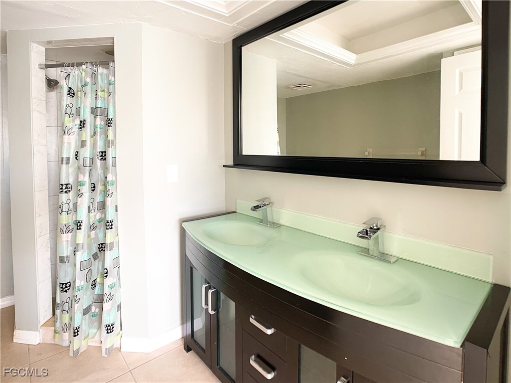 1156 Southwest 47th Terrace Cape Coral, FL 33914 - Photo 5 of 13 a bathroom with a sink and a mirror