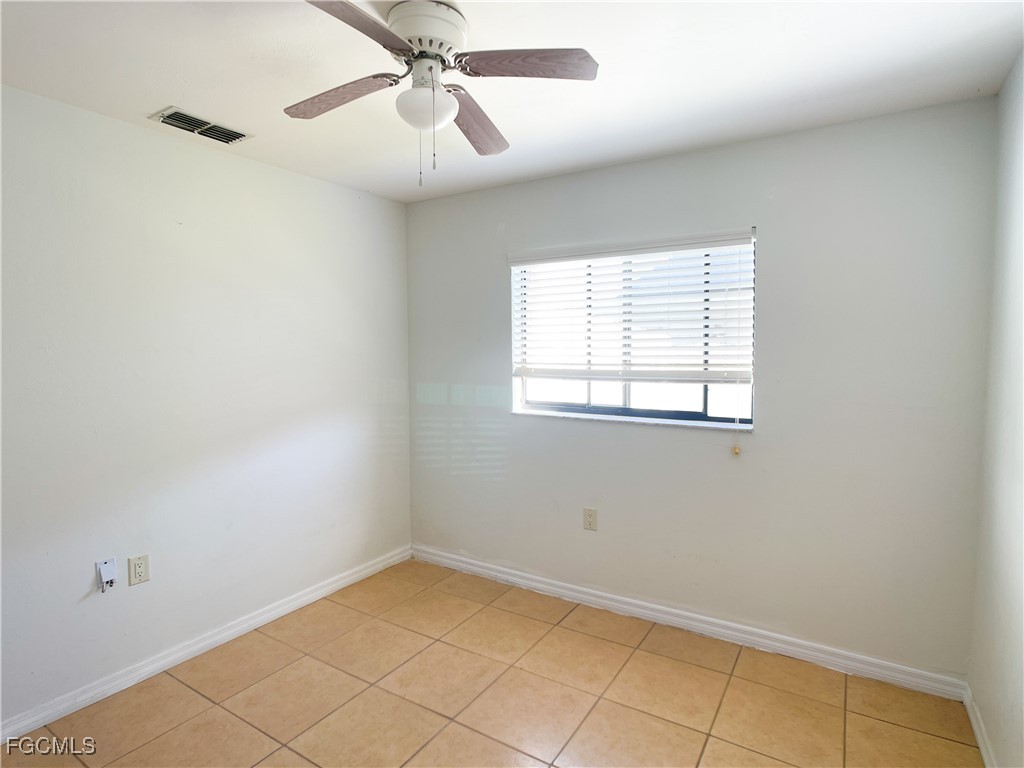 1156 Southwest 47th Terrace Cape Coral, FL 33914 - Photo 6 of 13 an empty room with a window and a fan