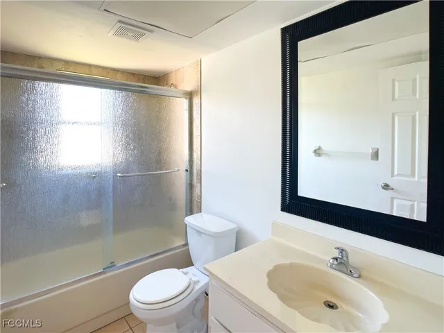 a bathroom with a sink mirror toilet and shower
