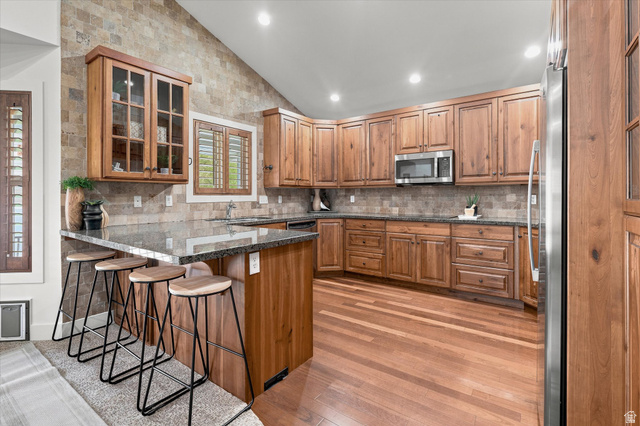 689 Apple Drive Logan, UT 84321 - Photo 10 of 52 Kitchen featuring wood-finish cabinetry, granite countertops, and stainless steel appliances