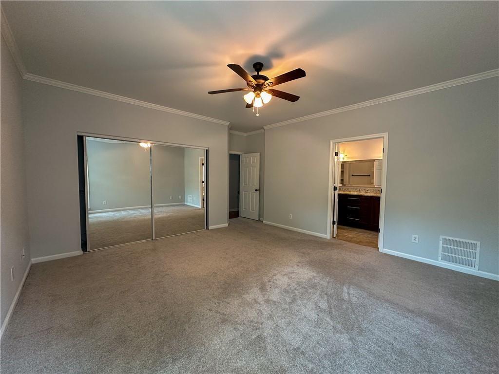 3255 Park Chase Alpharetta, GA 30022 - Photo 11 of 27 an empty room with closet and a ceiling fan
