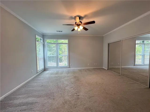 a view of a livingroom with a ceiling fan and window