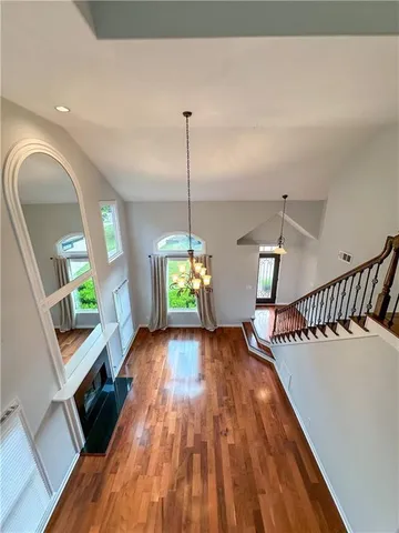 a view of entryway and hall with wooden floor