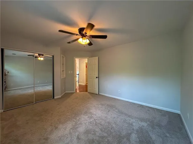 a view of a livingroom with a ceiling fan and chandelier fan