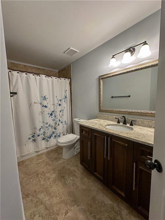3255 Park Chase Alpharetta, GA 30022 - Photo 23 of 27 a bathroom with a granite countertop sink toilet and shower