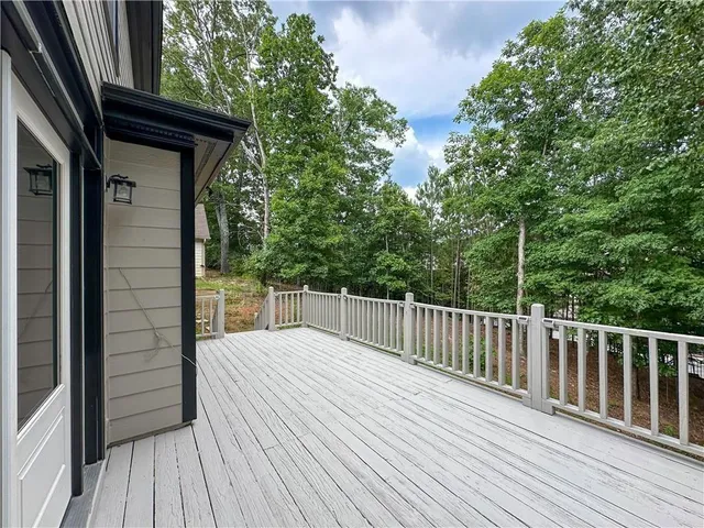 a view of backyard with a deck and wooden floor