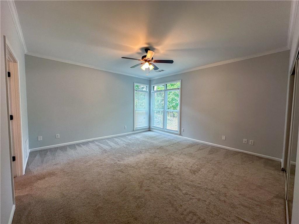 3255 Park Chase Alpharetta, GA 30022 - Photo 10 of 27 an empty room with windows and fan