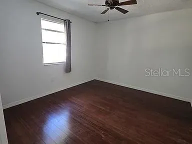 a view of a room with wooden floor closet and windows