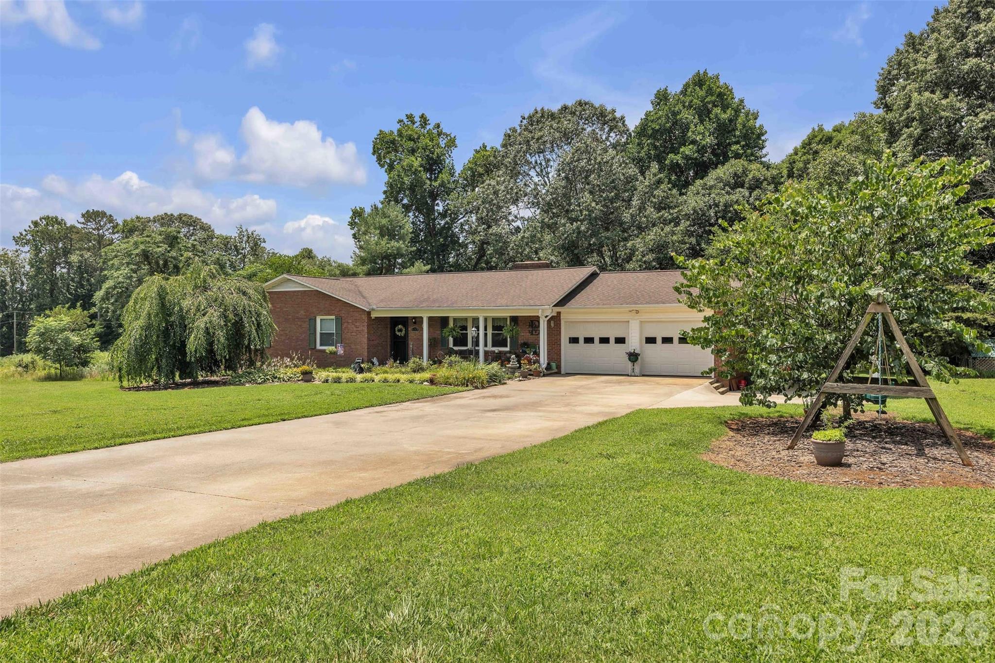 137 Proust Road Statesville, NC 28625 - Photo 2 of 47 a front view of a house with a garden and trees