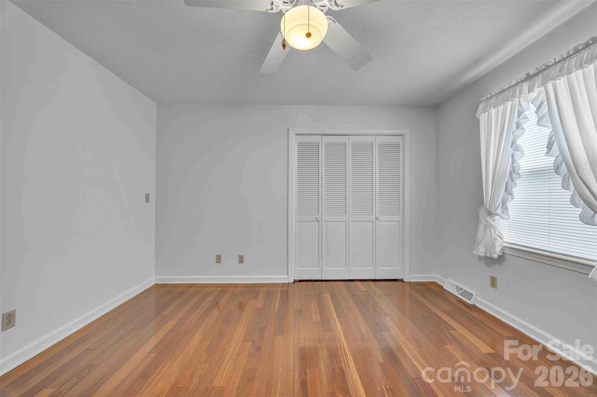 137 Proust Road Statesville, NC 28625 - Photo 25 of 47 wooden floor in an empty room with a window