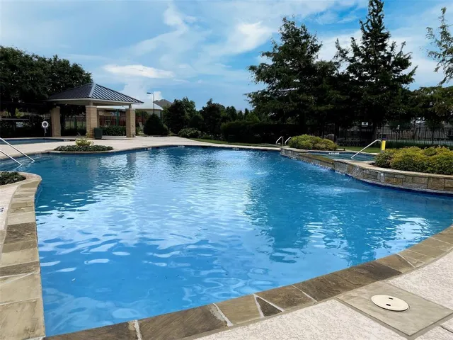 a view of a swimming pool with lounge chair