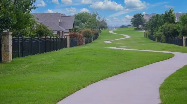 a view of a field of grass and a small yard