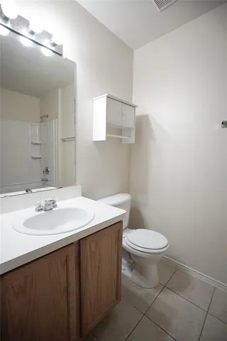 a bathroom with a sink a toilet and mirror