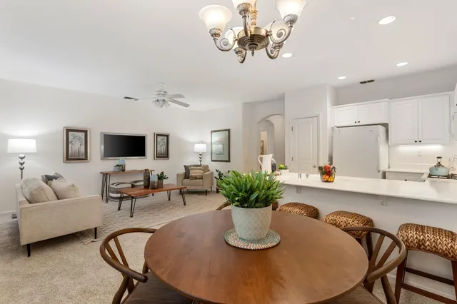 a dining room with furniture a livingroom and chandelier