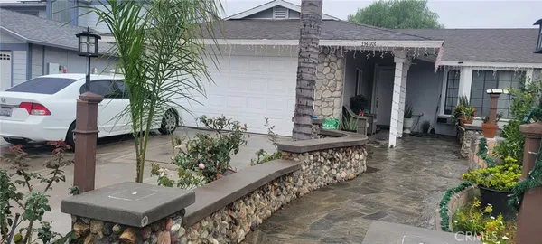 a backyard of a house with table and chairs