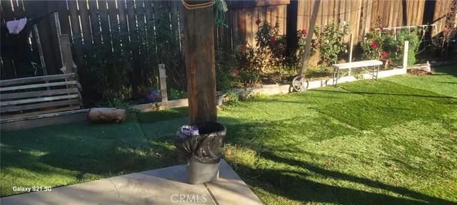 a view of a garden with a bench in front of house