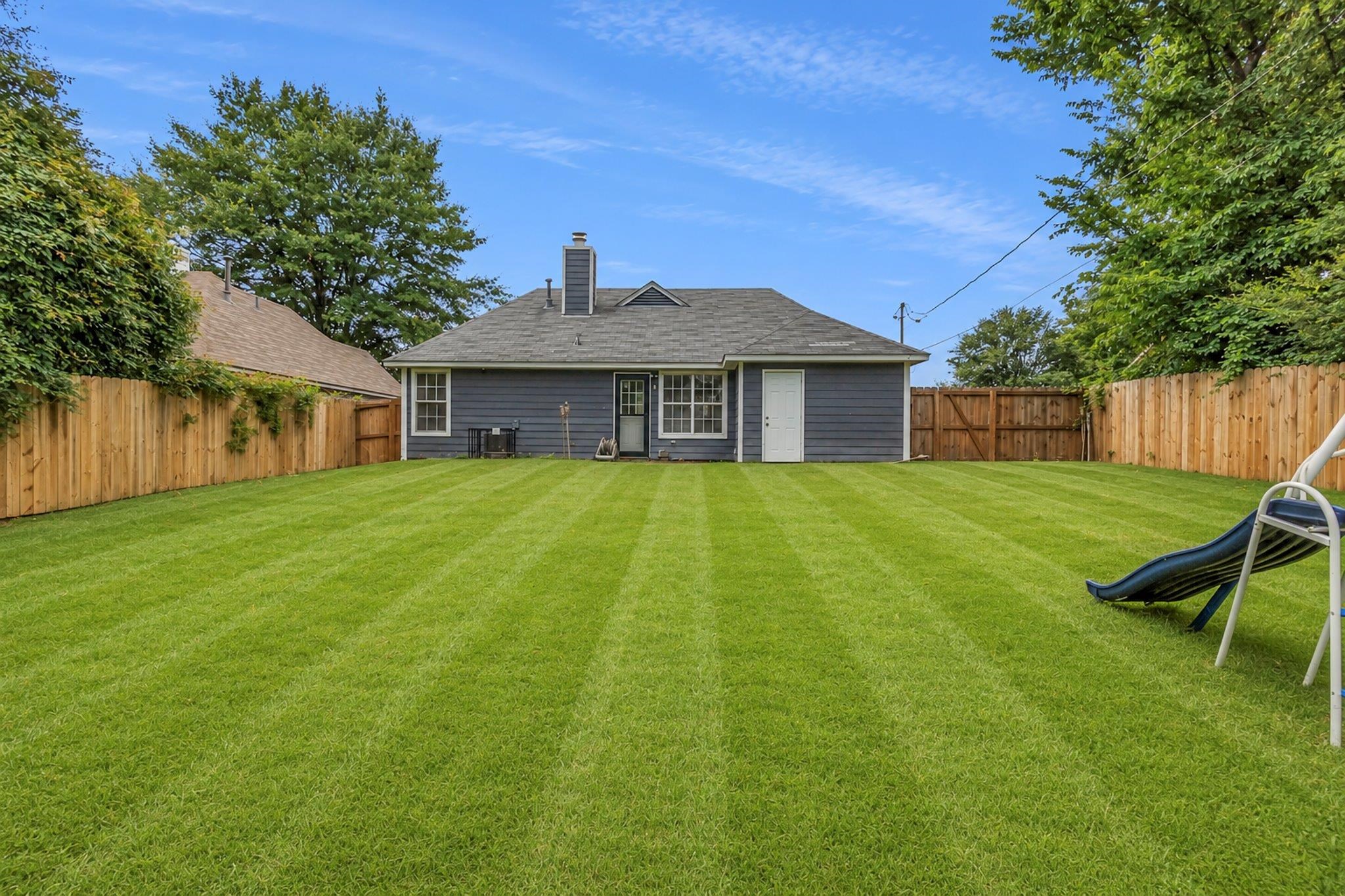 5930 Chadwell Road Millington, TN 38053 - Photo 17 of 17 Expansive rear yard featuring a large grass lawn