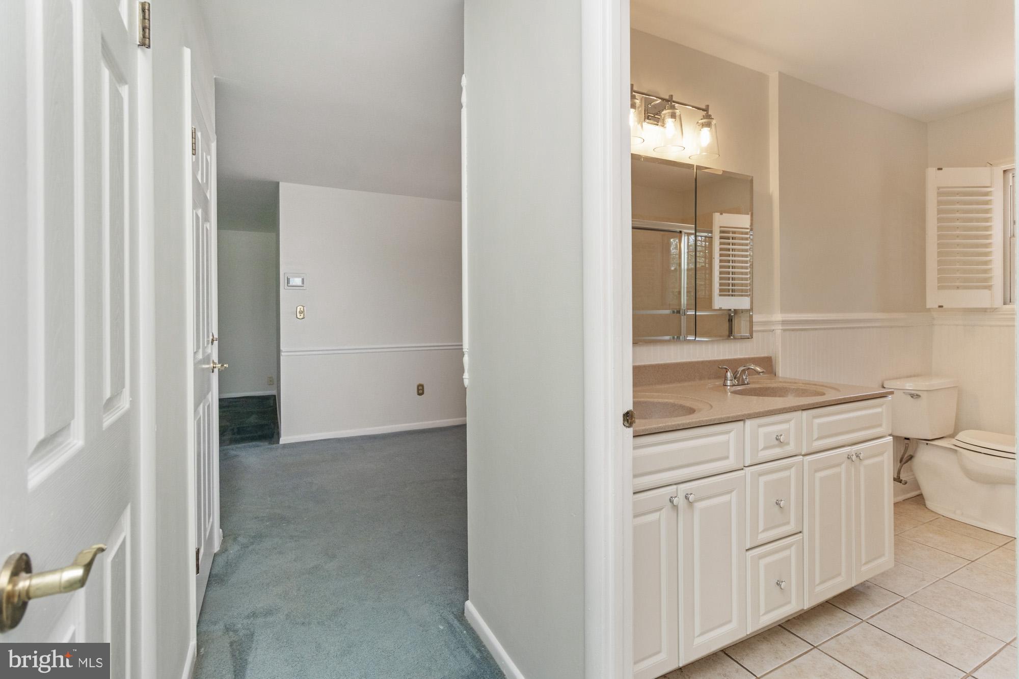 1429 Adamsview Road Baltimore, MD 21228 - Photo 15 of 44 a bathroom with a toilet sink and mirror