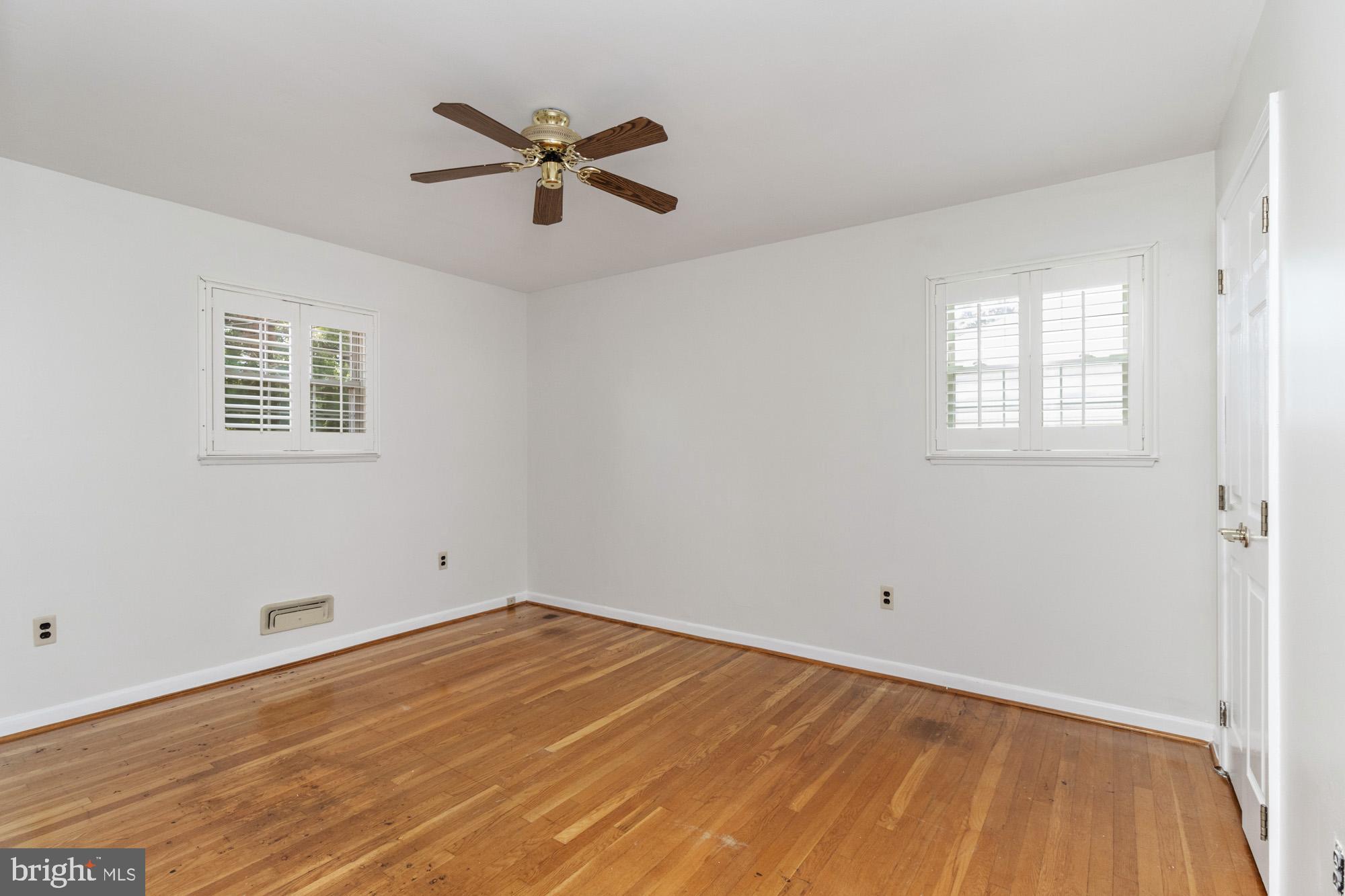 1429 Adamsview Road Baltimore, MD 21228 - Photo 21 of 44 an empty room with a window and a ceiling fan