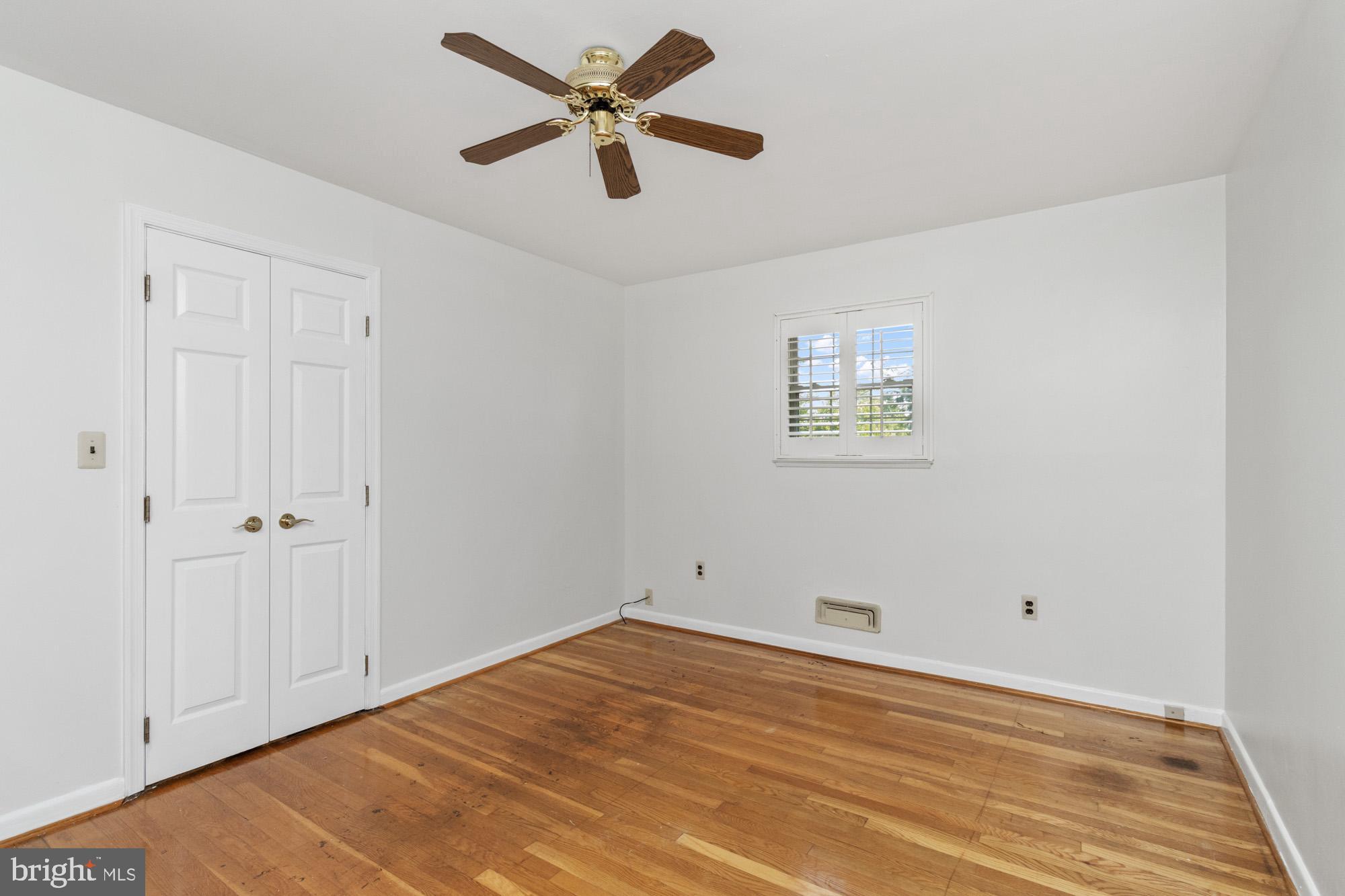 1429 Adamsview Road Baltimore, MD 21228 - Photo 22 of 44 an empty room with a window and a ceiling fan