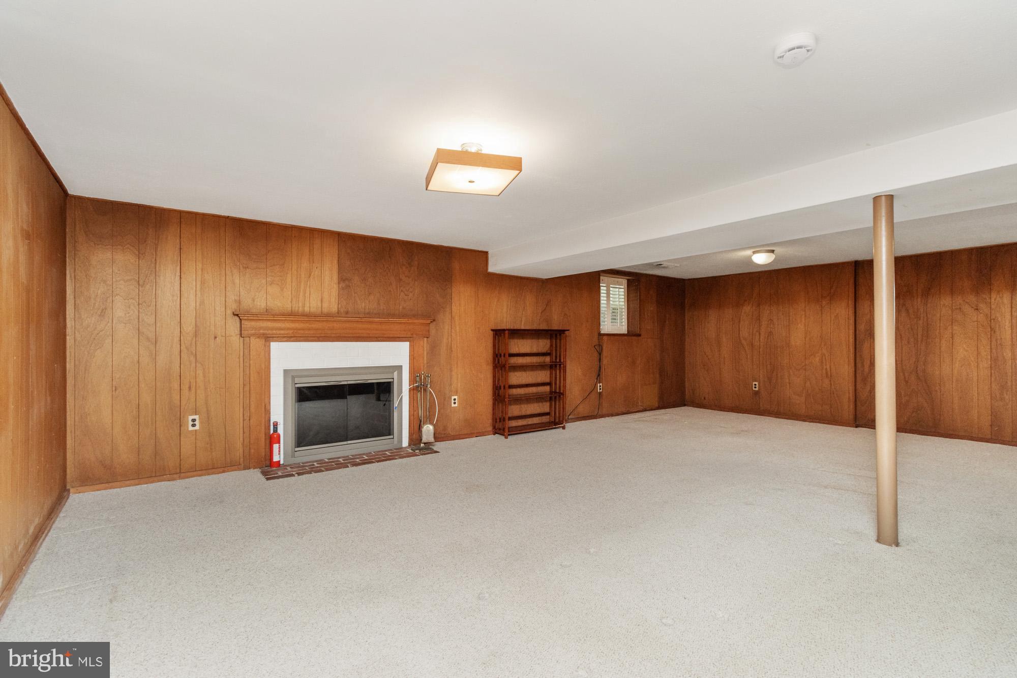1429 Adamsview Road Baltimore, MD 21228 - Photo 24 of 44 a view of an empty room with a fireplace and a window