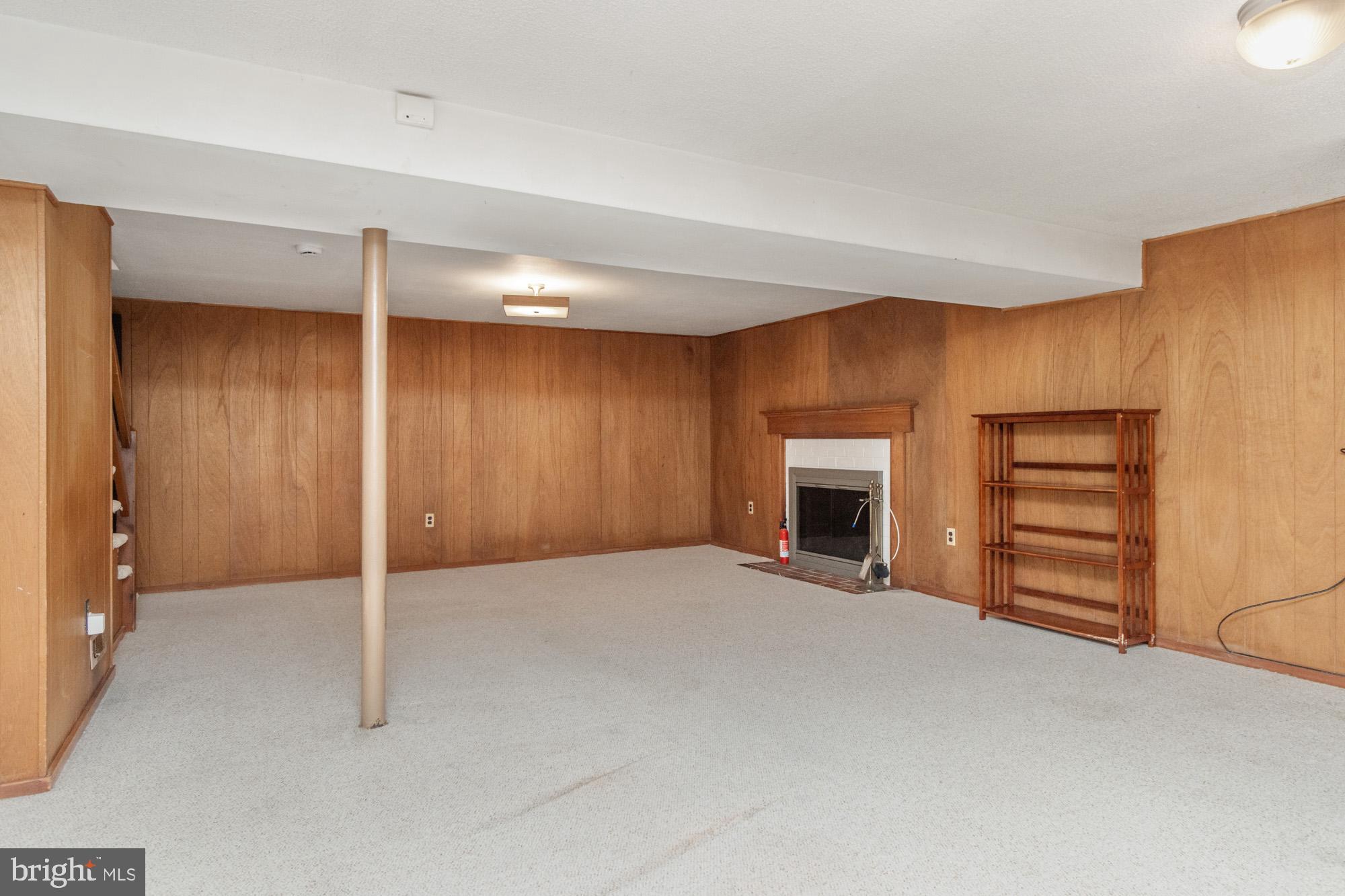 1429 Adamsview Road Baltimore, MD 21228 - Photo 26 of 44 a view of an empty room with a fireplace and a window